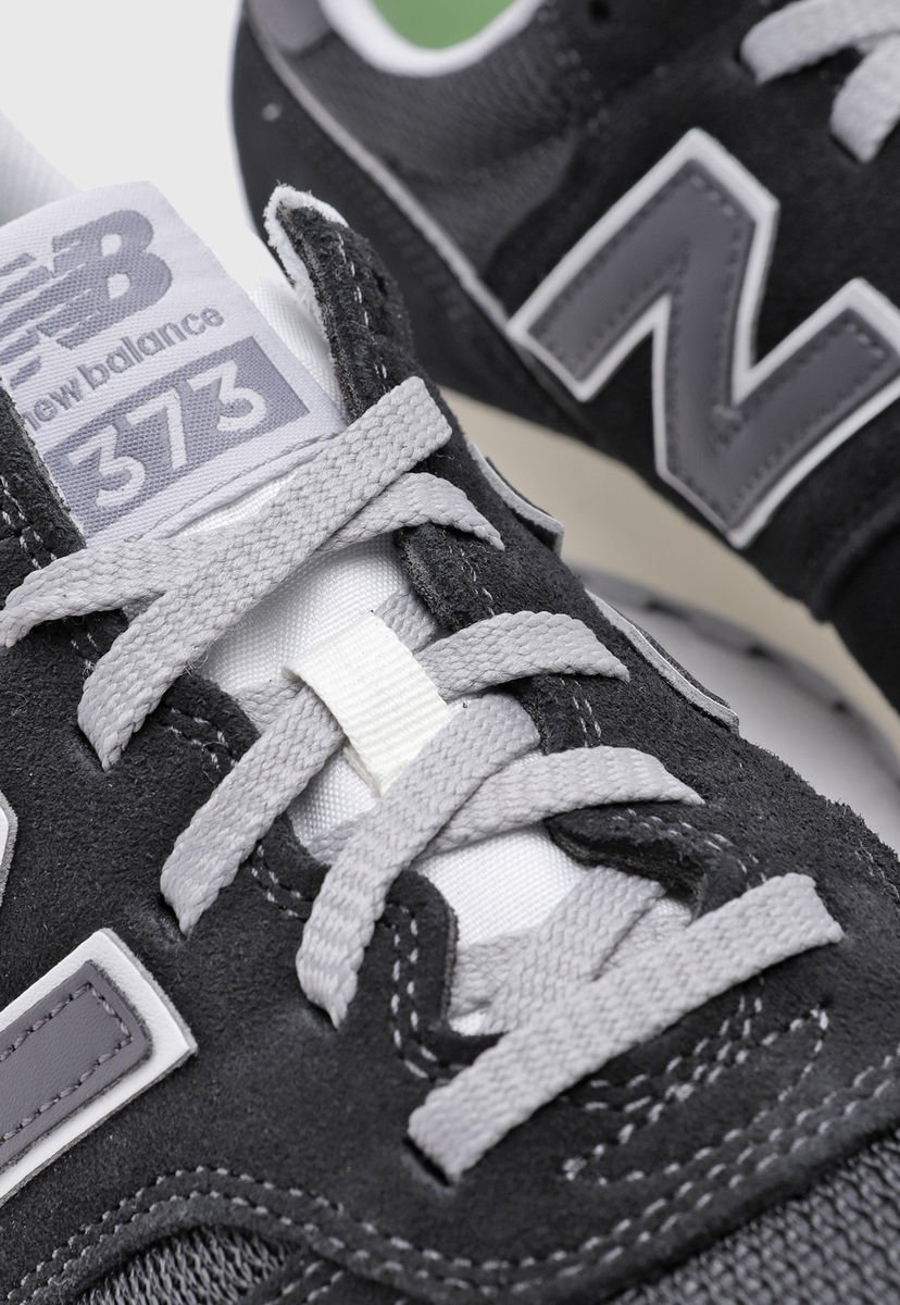 New balance 373 negras blancas best sale